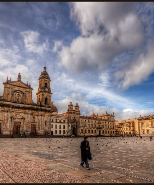 The Plaza de Bolivar is the main square in Bogota, Colombia. I was fortunate to stay close by so I headed out to the plaza in the morning, in the early sun. The church is the main cathedral, Catedral Primada, and the buildng on the right the Congress building.

ISO 100, 10mm, f9 (1/400, /1600, 1/400, 1/100) handheld. HDR processed in Photomatix Details Enhancer.  Imagenomics Noiseware. The warm look is the result of the Nik Skylight Filter and Indian Summer filters. Sharpened with Smart Sharpen and Freaky Details.